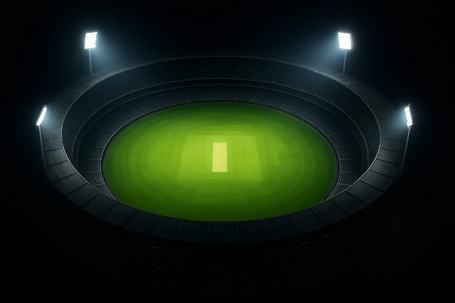 Aerial night view of cricket stadium with floodlights and vibrant green pitch